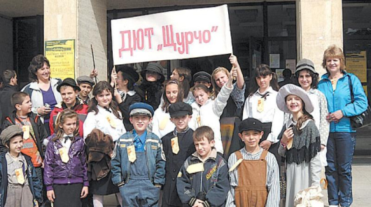 Малките актьори от “Щурчо” гордо позират с наградата пред сградата на театъра в Шумен