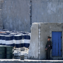 Севернокорейски войник охранява партида вносни стоки от Китай. Сн.: БТА